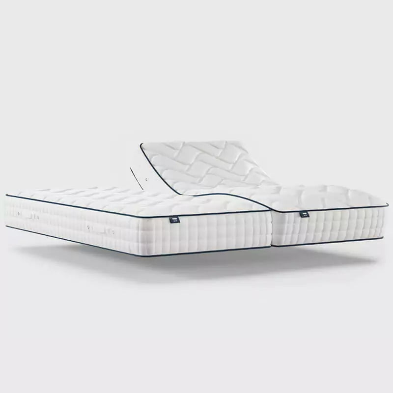 The Opera Gel 1000 Adjustable Mattress is a comfortable, multilayer mattress with a 2/5 firmness, featuring 1000 pocket springs, high-density foam shell, memory and gel-infused foams, carry handles, and a ventilated top cover.